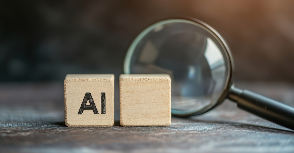 AI tools for schools | Wooden blocks reading AI with magnifying glass behind them